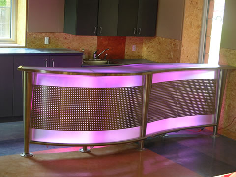 Steel counter combined with glass and color kinetic lighting